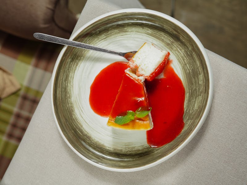 NY-style cheesecake slice with strawberry topping